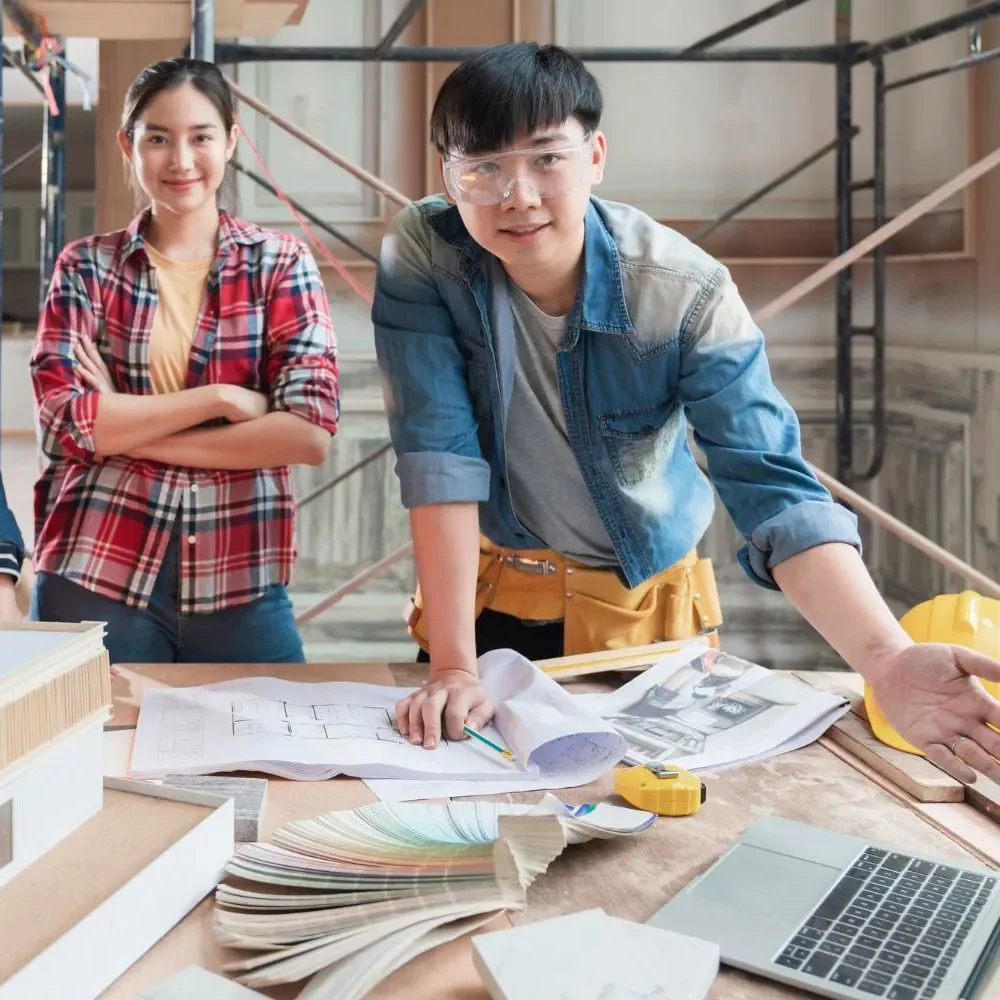 Architects-discussing-a-building-model-with-blueprints